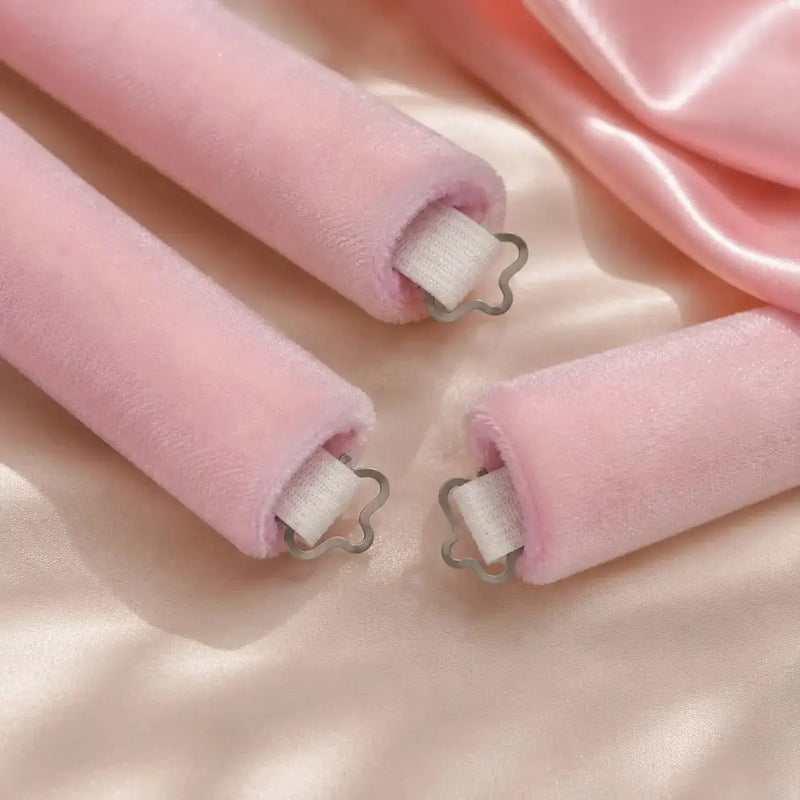 Close-up of pink velvet heatless hair rollers designed to reduce slipping