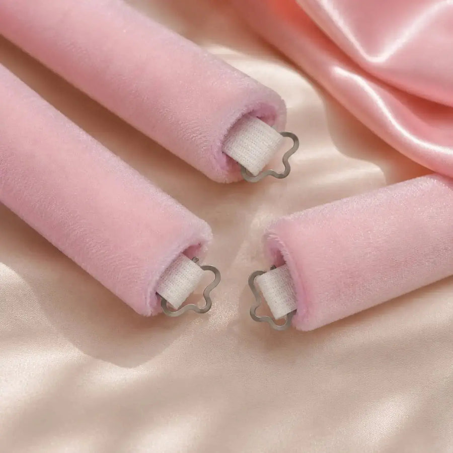 Close-up of pink velvet heatless hair rollers designed to reduce slipping