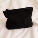 Black toiletry bag for hair accessories and heatless curlers