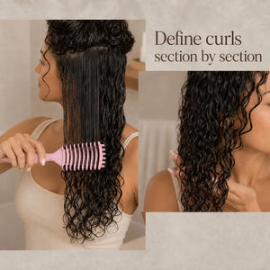 Woman using a brush for curly hair to define natural curls section by section on damp hair
