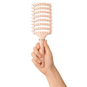 Pink anti static brush held in hand for easy hair styling