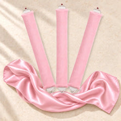 Revitalysse pink velvet heatless curling rollers with matching pink satin scarf, designed to create soft, natural overnight curls without heat.